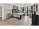 Bedroom features tray ceilings, wood floors, neutral colors, and large windows at 11057 Hollow Bay Dr, Winter Garden, FL 34787