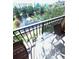 Balcony featuring a glass table and chairs with a view of the pond and fountain at 12527 Floridays Resort Dr # 506-E, Orlando, FL 32821