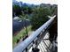 Balcony featuring a glass table and chairs with a view of the pond and fountain at 12527 Floridays Resort Dr # 506-E, Orlando, FL 32821