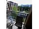 View from balcony features a lake with water fountain and tropical landscaping at 12527 Floridays Resort Dr # 506-E, Orlando, FL 32821