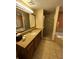 Well-lit bathroom featuring granite countertops, a sink, walk-in shower, and a separate bathtub at 12527 Floridays Resort Dr # 506-E, Orlando, FL 32821