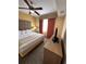 Comfortable bedroom featuring a ceiling fan, window with curtains, and a convenient TV on a dresser at 12527 Floridays Resort Dr # 506-E, Orlando, FL 32821
