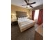 Inviting bedroom featuring a king-sized bed, ceiling fan, and a dresser with TV at 12527 Floridays Resort Dr # 506-E, Orlando, FL 32821