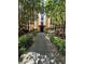 Beautifully landscaped walkway leading to the building entrance, surrounded by lush greenery and mature trees at 12527 Floridays Resort Dr # 506-E, Orlando, FL 32821