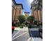 Exterior view of the building showcasing its architectural design, landscaping, and parking at 12527 Floridays Resort Dr # 506-E, Orlando, FL 32821