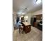 Open-concept kitchen featuring an island with seating, modern appliances, and a view into the dining area at 12527 Floridays Resort Dr # 506-E, Orlando, FL 32821
