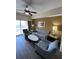 Cozy living room features balcony access, a sofa, and seating for relaxation at 12527 Floridays Resort Dr # 506-E, Orlando, FL 32821