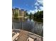 Relaxing view of a serene pond with a fountain, surrounded by lush greenery and a charming fence at 12527 Floridays Resort Dr # 506-E, Orlando, FL 32821