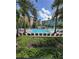 Stunning community pool surrounded by lush landscaping and comfortable lounge seating at 12527 Floridays Resort Dr # 506-E, Orlando, FL 32821