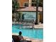 Sunny poolside view features many chairs, ladders into the pool, and resort signage at 12527 Floridays Resort Dr # 506-E, Orlando, FL 32821