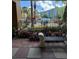 Scenic view of the pool from the walkway, framed by tropical plants and wrought iron fencing at 12527 Floridays Resort Dr # 506-E, Orlando, FL 32821