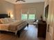 Cozy bedroom featuring natural light, a comfortable bed, and minimalist decor at 1266 Spotted Sandpiper Loop, Winter Springs, FL 32708