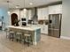 Modern kitchen with white cabinetry, stainless steel appliances, and a large center island at 1266 Spotted Sandpiper Loop, Winter Springs, FL 32708