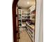 Walk-in pantry features custom shelves and ample storage for all your kitchen essentials at 1266 Spotted Sandpiper Loop, Winter Springs, FL 32708