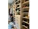 Spacious walk-in closet with custom shelving for shoes and folded clothes, and a plush bench at 1266 Spotted Sandpiper Loop, Winter Springs, FL 32708