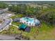 An aerial view of a planned community showcasing a pool, playground and common areas at 1323 Berry Ln, Davenport, FL 33837