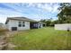 Lush backyard with a well-maintained lawn, privacy fence, and a screened-in porch at 1323 Berry Ln, Davenport, FL 33837