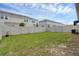 Spacious backyard with a well-kept lawn and a privacy fence enclosing the property at 1323 Berry Ln, Davenport, FL 33837