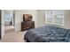 Relaxing bedroom features a large window and decorative dresser at 1323 Berry Ln, Davenport, FL 33837