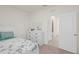 Comfortable bedroom with a white dresser and a doorway leading to an adjacent bathroom at 1323 Berry Ln, Davenport, FL 33837