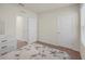 Cozy bedroom with neutral carpet, a large white dresser, and a floral-patterned comforter at 1323 Berry Ln, Davenport, FL 33837
