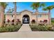 Inviting clubhouse with well-manicured landscaping and access gate for residents at 1323 Berry Ln, Davenport, FL 33837