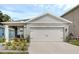 Charming single Gathering home with a two-car garage and beautiful landscaping at 1323 Berry Ln, Davenport, FL 33837