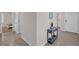 Open hallway with console table that leads to the front door, laundry and bedroom at 1323 Berry Ln, Davenport, FL 33837