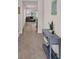Inviting hallway with console table, art and ceramic tile that leads to the living room at 1323 Berry Ln, Davenport, FL 33837