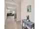 Inviting hallway with console table, art and ceramic tile that leads to the living room at 1323 Berry Ln, Davenport, FL 33837