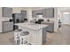 Bright kitchen with stainless appliances, gray cabinets, an island and breakfast bar at 1323 Berry Ln, Davenport, FL 33837