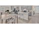 Bright kitchen with stainless appliances, gray cabinets, an island and breakfast bar at 1323 Berry Ln, Davenport, FL 33837