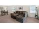 Comfortable living room with a large sectional sofa and natural light at 1323 Berry Ln, Davenport, FL 33837