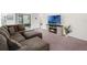 Carpeted living room with a large sectional couch and a fireplace at 1323 Berry Ln, Davenport, FL 33837