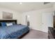 Bedroom featuring a bed with a dark wood headboard and an adjoining bathroom at 1323 Berry Ln, Davenport, FL 33837