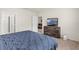 Bedroom featuring a bed with a dark wood headboard and dresser with a television at 1323 Berry Ln, Davenport, FL 33837