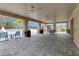 A covered outdoor lounge space with ceiling fans, seating, and a poolside view at 1323 Berry Ln, Davenport, FL 33837