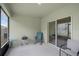 Covered patio featuring a rocking chair, grill, and sliding glass doors to the interior at 1323 Berry Ln, Davenport, FL 33837