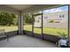 Screened-in patio overlooking a well-maintained backyard with a view of the surrounding neighborhood at 1323 Berry Ln, Davenport, FL 33837
