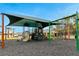 A shaded playground with slides, swings, and climbing features for children to enjoy at 1323 Berry Ln, Davenport, FL 33837