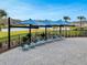 Relaxing poolside loungers under shade structures offer a serene escape by the lake at 1323 Berry Ln, Davenport, FL 33837