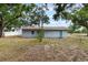 Backyard view of a single-story home with a new roof and an expansive yard at 1341 W Belmar St, Lakeland, FL 33815