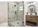 Bathroom featuring a glass-enclosed shower with marble tiling and a modern vanity at 1341 W Belmar St, Lakeland, FL 33815