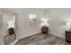 Bedroom features stylish gray wood flooring, a window, and an elegant floor-length mirror at 1341 W Belmar St, Lakeland, FL 33815
