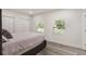 Bedroom featuring gray wood floors, two windows and dual closets at 1341 W Belmar St, Lakeland, FL 33815