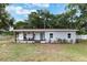 Charming single-story home with a covered front porch and a combination of white and gray exterior at 1341 W Belmar St, Lakeland, FL 33815
