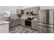 Modern kitchen with stainless steel appliances, granite countertops, gray cabinets and subway tile backsplash at 1341 W Belmar St, Lakeland, FL 33815