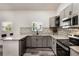 Modern kitchen with granite counters, stainless appliances, and gray cabinets at 1341 W Belmar St, Lakeland, FL 33815
