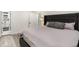 Spacious main bedroom featuring stylish gray wood floors and an adjoining bathroom at 1341 W Belmar St, Lakeland, FL 33815