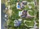A high angle aerial view shows a landscaped estate with a swimming pool and multiple docks on the lake at 1455 Kelso Blvd, Windermere, FL 34786